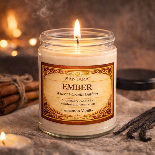 Santara Ember candle with cinnamon sticks and vanilla beans on a textured surface