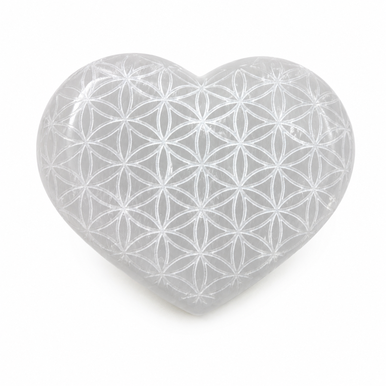 Heart-shaped crystal with Flower of Life pattern on a white background