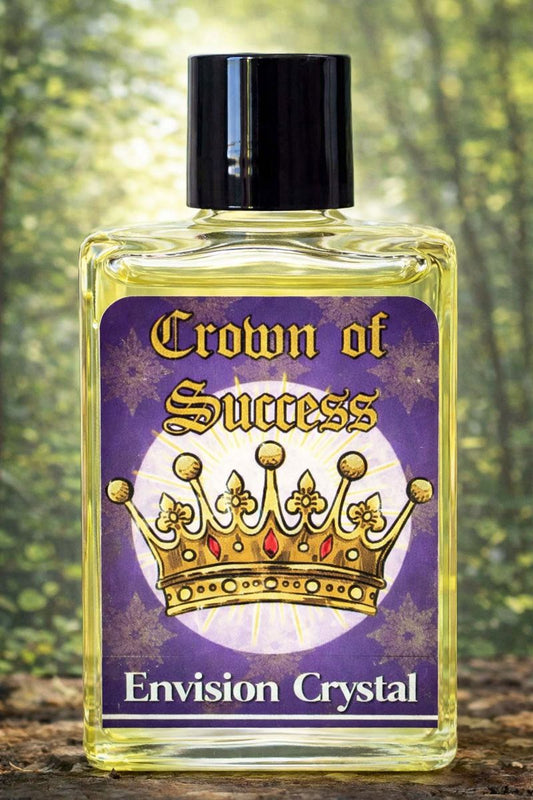 Bottle labeled 'Crown of Success Envision Crystal' with a purple label featuring a gold crown design, against a blurred natural background.