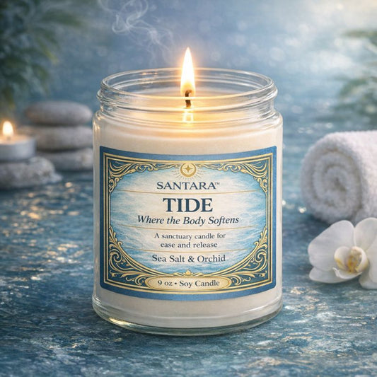 Santara Tide hand poured soy candle with a label on a blue textured surface with candles and stones in the background